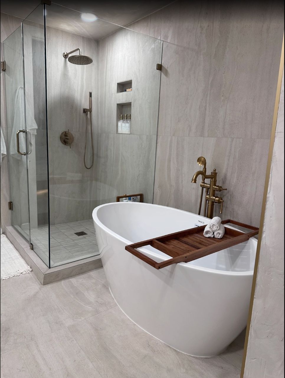 Marble walk-in shower with gold fixtures