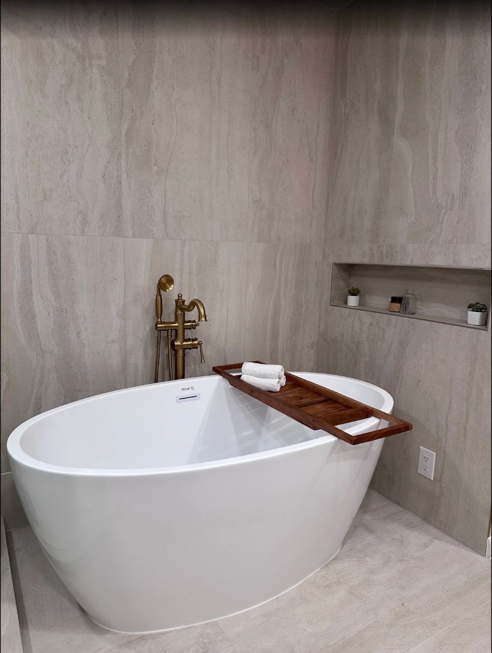 Freestanding soaking tub with gold tub filler